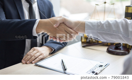 Businessman shaking hands with a lawyer or judge After signing the contract and the agreement is complete, Approval of an agreement between business and law, End of the legal case. 79001843