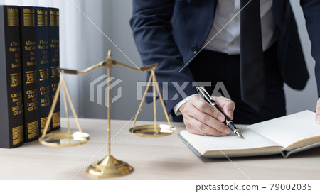 Lawyers or judges sign documents in accordance with legal and fair terms of agreement, Legal Ethics and Integrity, scales of justice, law hammer, Litigation and legal services. 79002035