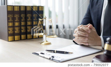 Lawyers or judges sign documents in accordance with legal and fair terms of agreement, Legal Ethics and Integrity, scales of justice, law hammer, Litigation and legal services. 79002077