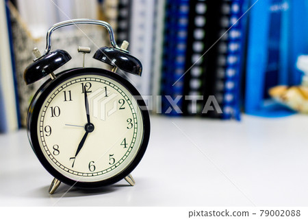 7 AM Clock on work desk in the office Time of businessman working concepts selective clock copy space 7 AM Clock on work desk in the office Time of businessman working concepts selective clock copy space 79002088