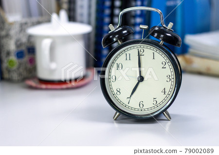 7 AM Clock on work desk in the office Time of businessman working concepts selective clock copy space 7 AM Clock on work desk in the office Time of businessman working concepts selective clock copy space 79002089