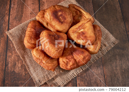 Fried peremyachi, belyashi, meat pies on a dark background. Traditional Russian pies. Russian, 79004212