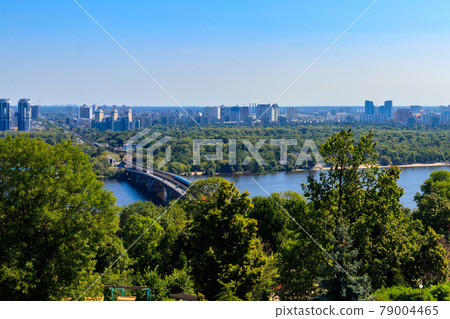 Aerial view of Metro bridge with subway train passing and the Dnieper river in Kiev, Ukraine. Kyiv cityscape Aerial view of Metro bridge with subway train passing and the Dnieper river in Kiev, Ukraine. Kyiv cityscape 79004465