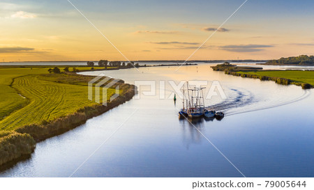 Aerial view of river with ship at sunset 79005644