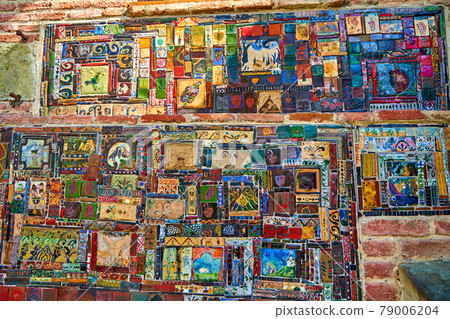 Texture. An old mosaic on the facade of the historical building of the puppet theater. Art object 79006204