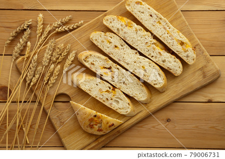 Loaf of organic bread on wooden background with cheese and ham. Fresh whole grain bread. Natural food concept. 79006731