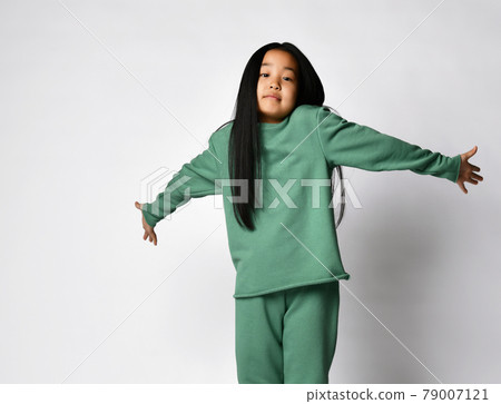 Cute asian preteen girl in green clothing showing Cute asian preteen girl in green clothing showing 79007121