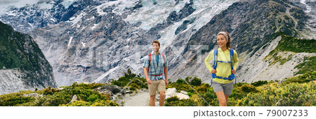 New Zealand backpacking hikers hiking on walking trail Hooker Valley Track. Mountains nature landscape panoramic banner. Couple on adventure 79007233