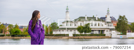 Spring woman walking in city park relaxing on weekend. Person enjoying lake view in Copenhagen, Denmark. lifestyle activity, people outside. Banner panorama. Spring woman walking in city park relaxing on weekend. Person enjoying lake view in Copenhagen, Denmark. lifestyle activity, people outside. Banner panorama. 79007254