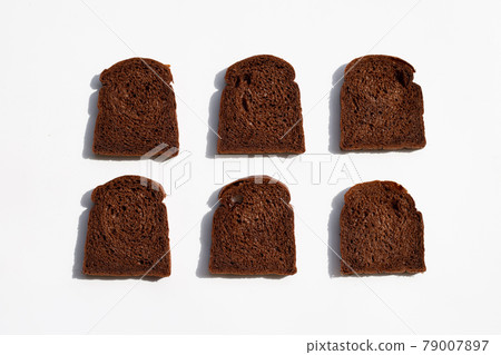 Dark cocoa bread on white background. 79007897