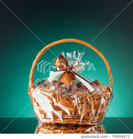 gift basket on emerald background 79009872