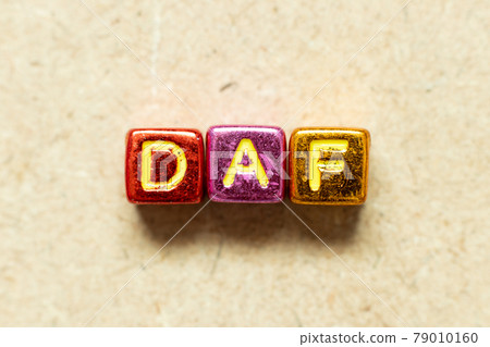 Metallic color alphabet letter block in word DAF (Abbreviation of Delivered at frontier) on wood background 79010160