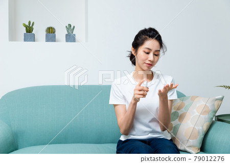 Girl disinfecting hands with alcohol Girl disinfecting hands with alcohol 79012276