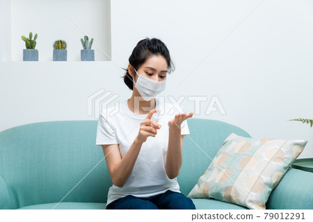 Girl disinfecting hands with alcohol Girl disinfecting hands with alcohol 79012291