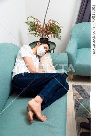 Sick girl wearing a mask Sick girl wearing a mask 79012302