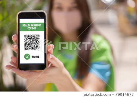 Portrait travel woman in face mask with digital app health passport covid19 qr code on smartphone Portrait travel woman in face mask with digital app health passport covid19 qr code on smartphone 79014675
