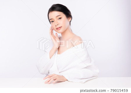 Beautiful young Asian woman wearing bathrobe on white background, Face care, Facial treatment, 79015459