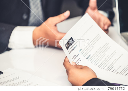 Human resources department manager reads CV resume 79015752