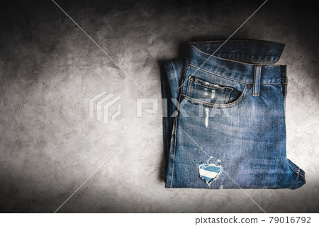 Jeans Pant lay on Cement Floor. Fashion, Clothes for any Gender, Classic Wearing for Diversity. Top View, Dark tone Jeans Pant lay on Cement Floor. Fashion, Clothes for any Gender, Classic Wearing for Diversity. Top View, Dark tone 79016792