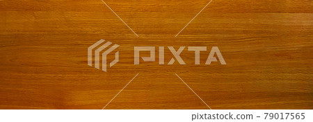 Background image of a horizontally long medium brown board with wood grain 79017565