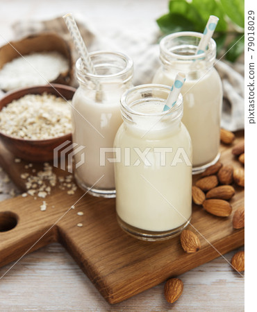 Alternative types of vegan milks in glass bottles Alternative types of vegan milks in glass bottles 79018029