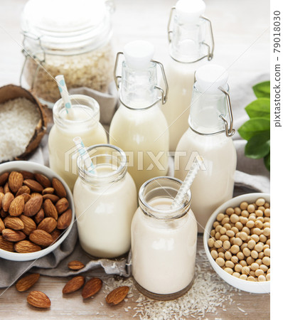 Alternative types of vegan milks in glass bottles Alternative types of vegan milks in glass bottles 79018030