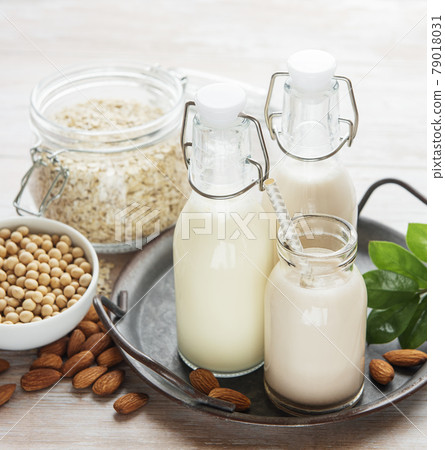 Alternative types of vegan milks in glass bottles Alternative types of vegan milks in glass bottles 79018031