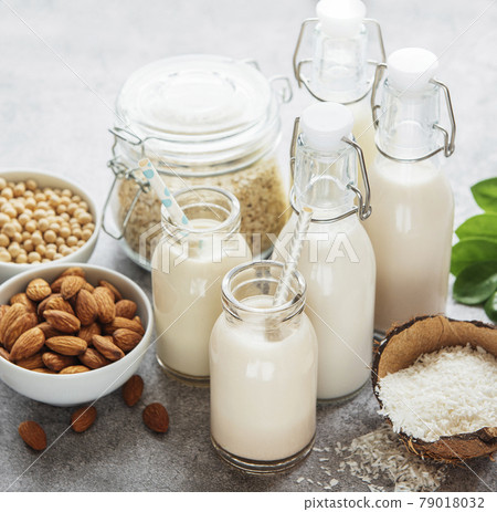 Alternative types of vegan milks in glass bottles Alternative types of vegan milks in glass bottles 79018032
