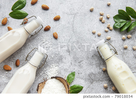 Alternative types of vegan milks in glass bottles Alternative types of vegan milks in glass bottles 79018034