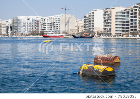 Yellow mooring buoys float in port of Sliema, Malta 79019053