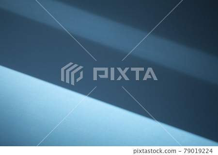 Blue wall shadows background. Sunlight with shadows on clean empty wall in room interior Blue wall shadows background. Sunlight with shadows on clean empty wall in room interior 79019224