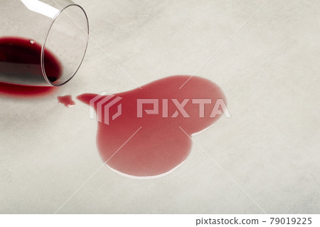 Wooden floor with overturned glass of red wine. Spilled wine on a wooden laminate parquet floor with moisture protection. Wooden floor with overturned glass of red wine. Spilled wine on a wooden laminate parquet floor with moisture protection. 79019225