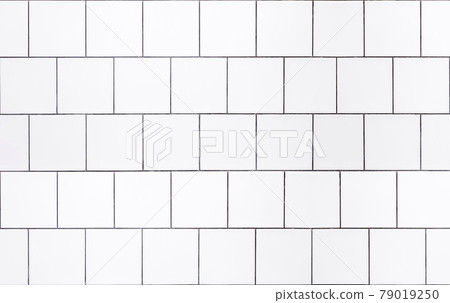 White tile background. Wall with white tiles for the interior of the kitchen or bathroom in the house. Decor, design and decoration of kitchen and bathroom interiors White tile background. Wall with white tiles for the interior of the kitchen or bathroom in the house. Decor, design and decoration of kitchen and bathroom interiors 79019250