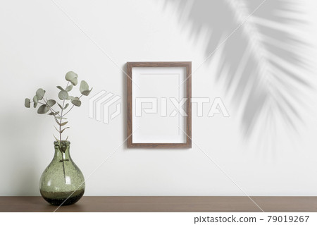 Mock up empty frame background. Empty decorative frame for a photo or painting in a light Scandinavian minimalist interior on a white clean wall. 79019267