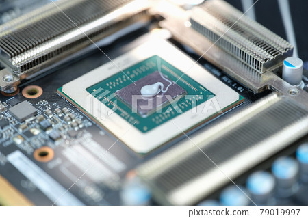 Thermal paste lying on microchip for video card closeup Thermal paste lying on microchip for video card closeup 79019997