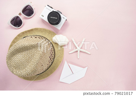 Flat lay traveler accessories on pastel pink background with small white camera, sunglasses, straw hat. Top view travel or vacation concept with copy space Flat lay traveler accessories on pastel pink background with small white camera, sunglasses, straw hat. Top view travel or vacation concept with copy space 79021017