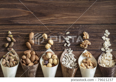 Variety of grains and mixed nuts on wooden background , top view with copy space Variety of grains and mixed nuts on wooden background , top view with copy space 79021237