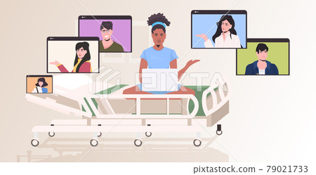 pregnant woman in hospital bed chatting with friends in web browser windows during video call online meeting 79021733