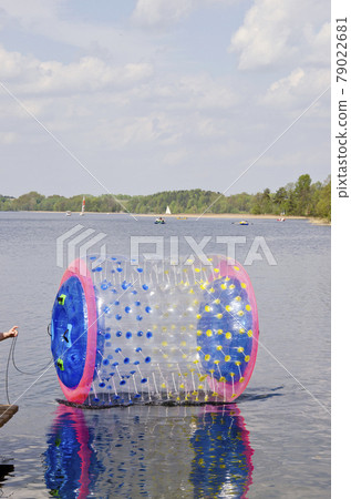 empty zorbing ball on lake water 79022681