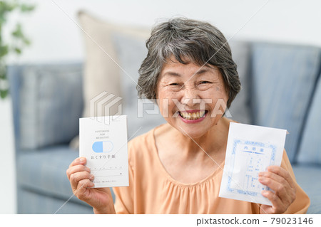 Senior women taking medicine supplements medicine notebook 79023146