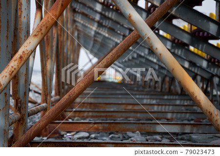 Rusty support pipes of the sports field stands. Construction fittings Rusty support pipes of the sports field stands. Construction fittings 79023473