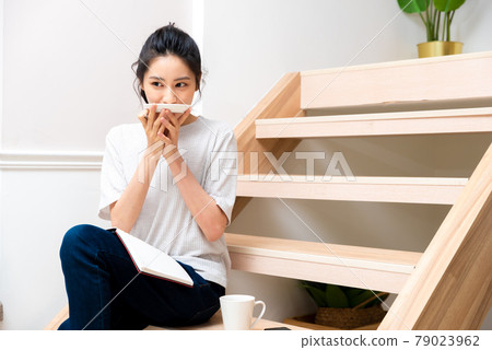 Girl sitting on wooden stairs enjoying dessert Girl sitting on wooden stairs enjoying dessert 79023962