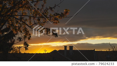 Suburban scene with sunset and dramatic sky 79024233