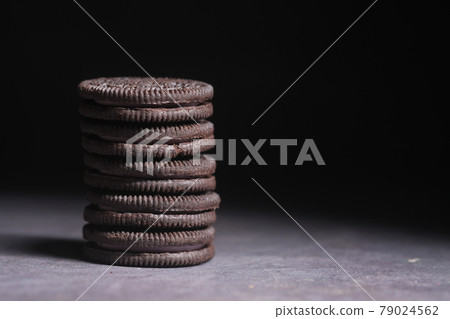 close up of sweet chocolate cookies against black background  79024562