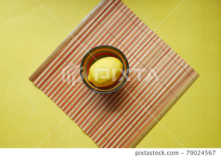 Yellow Lemon in bowl on yellow background with copy space . Yellow Lemon in bowl on yellow background with copy space . 79024567