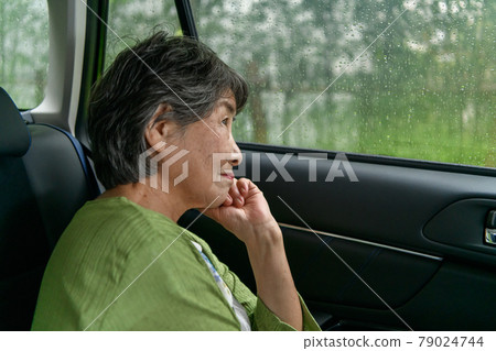 Senior woman car rain Senior woman car rain 79024744
