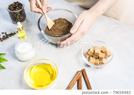 Woman mixing ingredients preparing coffee scrub for skin treatment 79026983