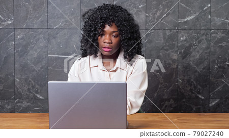 African-American businesswoman talks having video call African-American businesswoman talks having video call 79027240