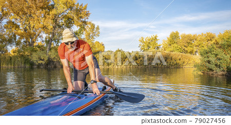 stand up paddling in fall colors 79027456