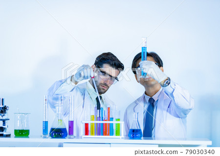 Team of research scientists analysing test trial new generation vaccine data. 79030340